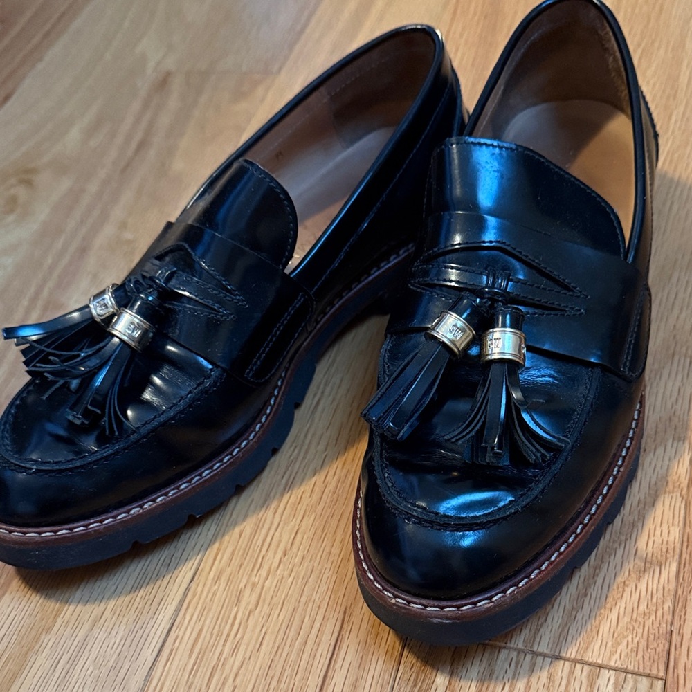 Stuart Weitzman Black Leather Tassel Loafers with Gold Accents